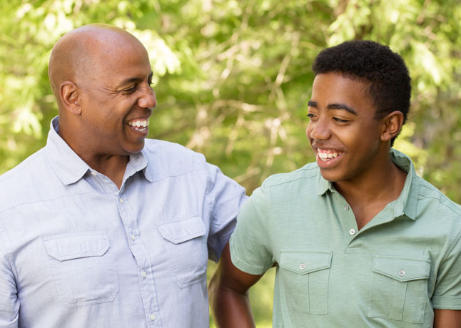 Man and teenager laughing together