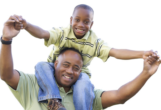 Man with young boy on shoulders smiling